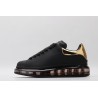 AMQ oversized sneakers black with gold heel