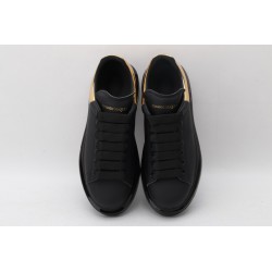 AMQ oversized sneakers black with gold heel