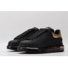 AMQ oversized sneakers black with gold heel