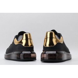 AMQ black oversized sneakers with gold heel