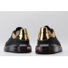 AMQ black oversized sneakers with gold heel