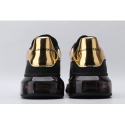 AMQ black oversized sneakers with gold heel