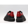 AMQ black oversized sneakers with red heel